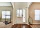 Open foyer with hardwood floors transitioning to carpet, showing abundant natural light at 3746 Okefenokee Rdg, Loganville, GA 30052