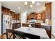 A well-lit kitchen with dark cabinets, stainless steel appliances, granite countertops, and a breakfast area at 3746 Okefenokee Rdg, Loganville, GA 30052