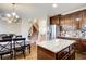 A well-lit kitchen with an island, stainless steel appliances, and an open floor plan leading to the living room and staircase at 3746 Okefenokee Rdg, Loganville, GA 30052