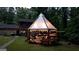 Backyard featuring a modern gazebo, an inviting deck area, and an enchanting string lights at 4567 Town Crier Sw Rd, Lilburn, GA 30047