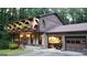 Two-story home with balconies showcasing flower boxes and an attached garage with open door at 4567 Town Crier Sw Rd, Lilburn, GA 30047
