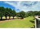 Private backyard featuring lush green lawn and a border of mature trees at 1241 Edgebrook Ln, Snellville, GA 30078