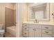 Bathroom with single sink vanity, large mirror, and a tiled shower and bathtub at 1241 Edgebrook Ln, Snellville, GA 30078