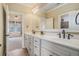 Bathroom with dual sinks, large mirror, and great natural light at 1241 Edgebrook Ln, Snellville, GA 30078