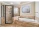 A soaking tub is featured next to a shower with glass doors at 1241 Edgebrook Ln, Snellville, GA 30078