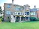Large brick home's rear exterior shows a deck, patio, and spacious backyard at 1241 Edgebrook Ln, Snellville, GA 30078