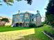 View of the back of a brick home with a deck, patio, and green lawn at 1241 Edgebrook Ln, Snellville, GA 30078