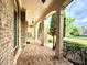 Inviting brick porch with brick columns, a brick floor, and decorative hanging lanterns at 1241 Edgebrook Ln, Snellville, GA 30078