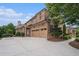 A spacious three-car garage with a long driveway for parking, surrounded by mature landscaping at 1241 Edgebrook Ln, Snellville, GA 30078