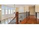 Well-lit hallway features hardwood floors, an iron-wrought railing, and a wall of windows at 1241 Edgebrook Ln, Snellville, GA 30078