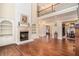 A grand living room featuring hardwood floors, a fireplace, and bright windows at 1241 Edgebrook Ln, Snellville, GA 30078