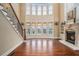 A grand living room featuring hardwood floors, a fireplace, and bright windows at 1241 Edgebrook Ln, Snellville, GA 30078