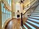 Bright living room features a fireplace, hardwood floors, and staircase with decorative iron spindles at 1241 Edgebrook Ln, Snellville, GA 30078