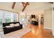 Spacious open-concept living room with hardwood floors, leading to a kitchen with a bar at 1241 Edgebrook Ln, Snellville, GA 30078
