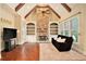 Comfortable living room with a stone fireplace, built-in shelving, hardwood floors, and natural light at 1241 Edgebrook Ln, Snellville, GA 30078