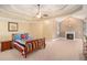 Spacious main bedroom with a fireplace, carpet flooring, and a tray ceiling at 1241 Edgebrook Ln, Snellville, GA 30078