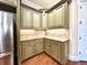 Pantry featuring custom cabinets with granite countertops and mosaic tile backsplash at 1241 Edgebrook Ln, Snellville, GA 30078
