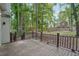 View of the back deck with wooden railing overlooking the large wooded lot at 220 Chinkapin Sw Cir, South Fulton, GA 30311