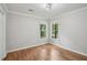 Bedroom featuring hardwood floors and dual windows at 220 Chinkapin Sw Cir, South Fulton, GA 30311