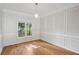 Dining room featuring hardwood floors, custom millwork, and a modern light fixture at 220 Chinkapin Sw Cir, South Fulton, GA 30311