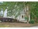 A two-story home nestled among trees features bay windows and mature landscaping at 220 Chinkapin Sw Cir, South Fulton, GA 30311