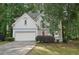 Charming two-story home with a well-maintained lawn, two car garage and a welcoming red front door at 220 Chinkapin Sw Cir, South Fulton, GA 30311