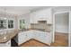 Well-equipped kitchen with white cabinets, granite counters, and an island with a sink at 220 Chinkapin Sw Cir, South Fulton, GA 30311