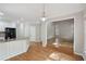 Bright and airy kitchen with white cabinets, hardwood floors, and a breakfast bar at 220 Chinkapin Sw Cir, South Fulton, GA 30311