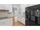 Kitchen with stone countertops, stainless steel appliances and views to another room at 220 Chinkapin Sw Cir, South Fulton, GA 30311