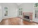 Cozy living room with hardwood floors and a fireplace with decorative tiles at 220 Chinkapin Sw Cir, South Fulton, GA 30311