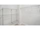 Empty walk-in closet equipped with sturdy metal shelving units at 220 Chinkapin Sw Cir, South Fulton, GA 30311