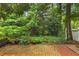 Secluded backyard with a brick patio and lush greenery at 2694 Greentree Se Dr, Marietta, GA 30067