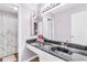 Sleek bathroom featuring a dark vanity, modern fixtures, and a shower with a patterned curtain at 2694 Greentree Se Dr, Marietta, GA 30067