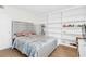 Bedroom with a gray bed frame, hardwood floors, and built-in shelves at 2694 Greentree Se Dr, Marietta, GA 30067