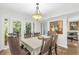 Elegant dining area featuring a chandelier, seating for six, and scenic views of the outdoors at 2694 Greentree Se Dr, Marietta, GA 30067