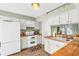 Well-lit kitchen featuring butcher block countertops and white appliances at 2694 Greentree Se Dr, Marietta, GA 30067