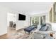 Open-concept living room with bright walls, wooden floors, and a dining area in the background at 2694 Greentree Se Dr, Marietta, GA 30067