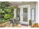 Outdoor patio featuring table and chairs and well-maintained landscaping providing a welcoming space at 2694 Greentree Se Dr, Marietta, GA 30067