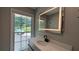 Modern bathroom with large window, floating vanity, and an illuminated mirror at 4807 Greenway Rd, Norcross, GA 30071