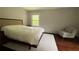 Bedroom with hardwood floors, chair, and natural light from the window at 4807 Greenway Rd, Norcross, GA 30071