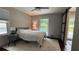 Cozy bedroom with neutral walls, ceiling fan, and natural light from the window at 4807 Greenway Rd, Norcross, GA 30071