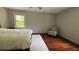Bedroom with hardwood floors, chair, and natural light from the window at 4807 Greenway Rd, Norcross, GA 30071