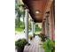 Inviting front porch adorned with hanging plants and colorful potted flowers, creating a warm welcome at 4807 Greenway Rd, Norcross, GA 30071