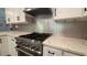 Close-up of a well-equipped kitchen with a stainless steel range and elegant backsplash at 4807 Greenway Rd, Norcross, GA 30071