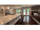 Gourmet kitchen features white cabinets, stainless appliances, quartz countertops, and access to an outdoor deck at 4807 Greenway Rd, Norcross, GA 30071