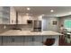Open-concept kitchen with white cabinets, stainless appliances, quartz counters and adjacent dining area at 4807 Greenway Rd, Norcross, GA 30071