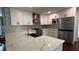 Bright, modern kitchen with white cabinets, stainless steel appliances, and a large island with a marble countertop at 4807 Greenway Rd, Norcross, GA 30071