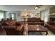 Open-concept living room with leather furniture flowing into a modern kitchen with stainless steel appliances at 4807 Greenway Rd, Norcross, GA 30071