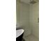Shower with light tile, shower head, and built-in bench at 4807 Greenway Rd, Norcross, GA 30071