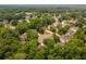 An aerial view of a neighborhood with mature trees surrounding well-maintained homes at 3801 Stonebriar Ln, Duluth, GA 30097